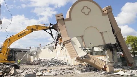 Front of building collapses gets destroyed by heavy equipment Stock Footage 125056038
