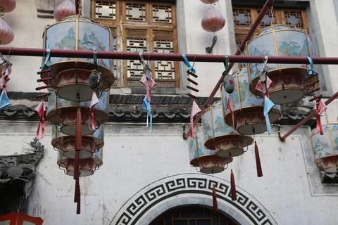 In front of the building hang several large and small lanterns with colorfu.. Stock Photos