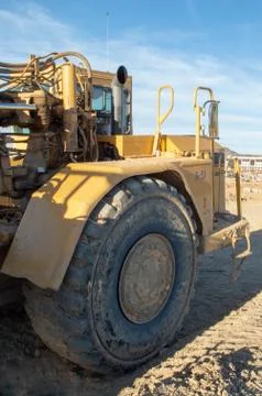 Front cab area of construction grader with tire Stockfoto's