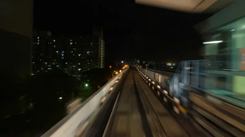 Front cabin view of modern driver-less metro train running through night city Stock Footage 137469634