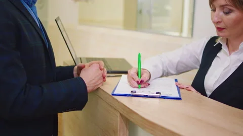 In front of the camera amazing mature man discussing with clinic assistant at Stock Footage 159016119