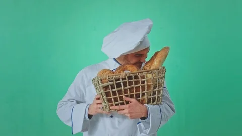 In front of the camera baker young man smelling the fresh bread then looking Stock Footage 125488008