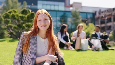 In front of the camera beautiful lady student in the college garden posing in Stock Footage 164862326