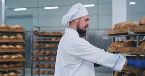 In front of the camera charismatic baker take some notes in the tablet of a Stock Footage 122934843