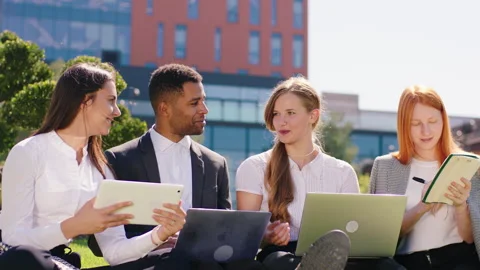 In front of the camera charismatic black guy student and his colleagues doing Video stock 194414509