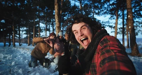 In front of the camera charismatic guy with curly hair and his friends make a Stock Footage 112631268