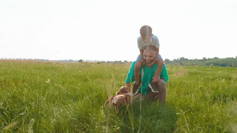 In front of the camera charismatic man and his cute boy on his back playing with Stock Footage 166851044