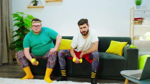 In front of the camera concentrated two friends one of them obese using weights Stock Footage 152413162