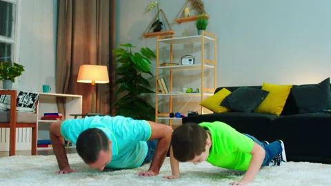 In front of the camera dad and his son happy and excited doing push-ups together Stock Footage 146188756