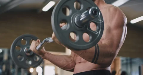 In front for the camera details of a bodybuilding man exercise with a weights Stock Footage 114765861