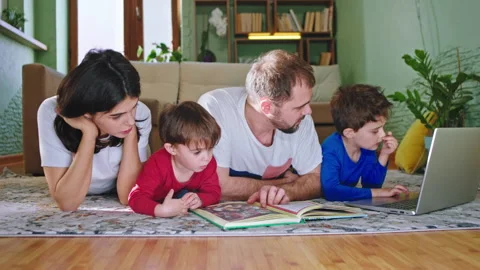 In front of the camera down on the floor in the living room mom and dad readying Stock Footage 139045443