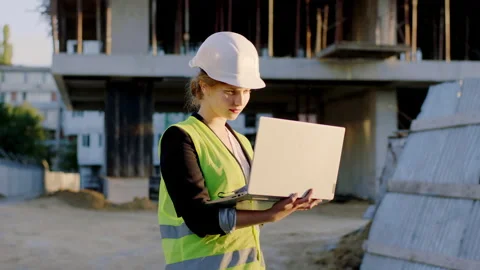 In front of the camera engineer woman with a laptop working at construction site Stock Footage 146606554