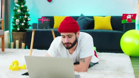 In front of the camera good looking man working online from the laptop while Video stock 160806007