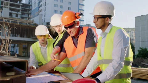 In front of the camera group of diverse specialists at construction site they Video stock 142016396