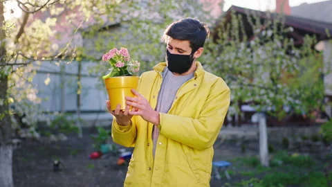 In front of the camera guy in the quarantine with a protective mask holding a Stock Footage 131661507