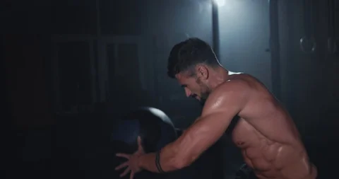 In front of the camera a hard workout training at cross fitness class guy with a Video stock 118608736