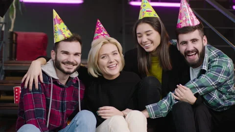 In front of the camera with a large white smile multiethnic friends celebrating Video stock 135919633