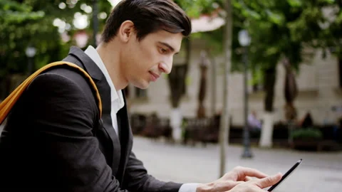 In front of the camera outside in the middle of the street young man student 스톡 동영상 146390479