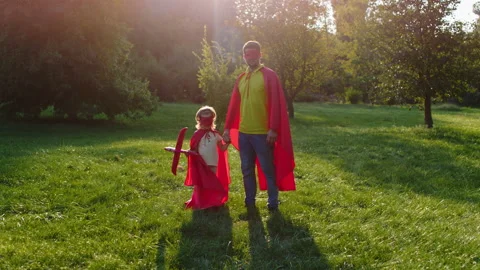 In front of the camera posing dad and son in a superhero suits they looking Stock Footage 171285921