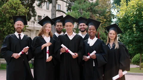 In front of the camera posing group of multiracial students graduates with Stock Footage 170082965