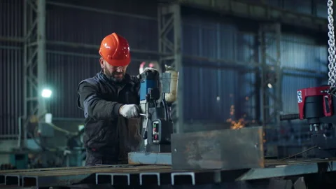 In front of the camera professional blacksmith in the manufacture working with Stock Footage 267827187