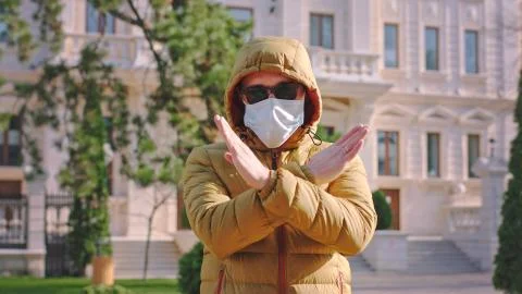 In front of the camera with a protective mask on face a guy suggesting to Stock Photos