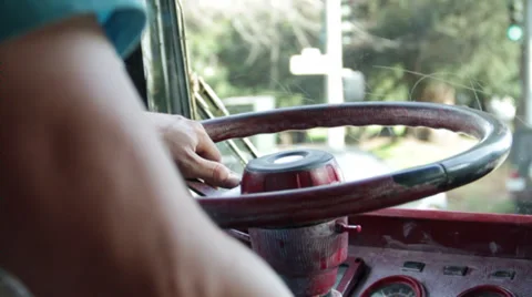 In front of the camera shows one person drives a bus by holding a steering Hippy Stock Footage 35418780