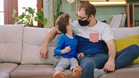 In front of the camera small boy with his dad stay at home in quarantine they Video stock 127713150
