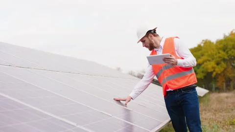 In front of the camera at solar panels farm ecological worker controlling the 스톡 동영상 164550701