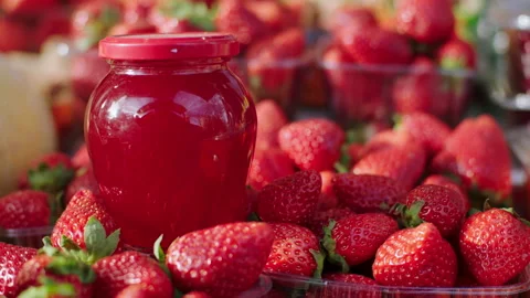 In front of the camera taking video of a farming eco jam from eco strawberry Stock Footage 166516537