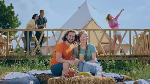 In front of the camera taking video of a smiling large country side couple Stock Footage 243108828