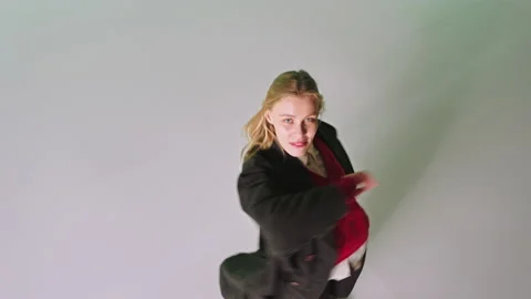 In front of the camera taking video from the top young woman dancing and moving Video stock 131559223