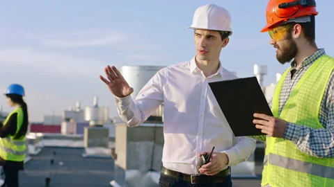 In front of the camera in the top of the construction building businessman have Video stock 143156908