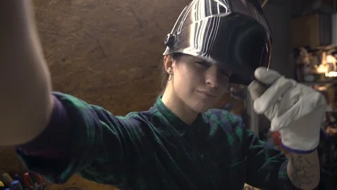 Front camera view portrait of young female welder in workshop. Gender equality Video stock 105242733
