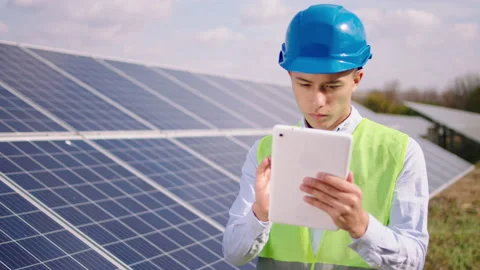 In front of the camera young ecological engineer with safety helmet at solar Stock Footage 163972564