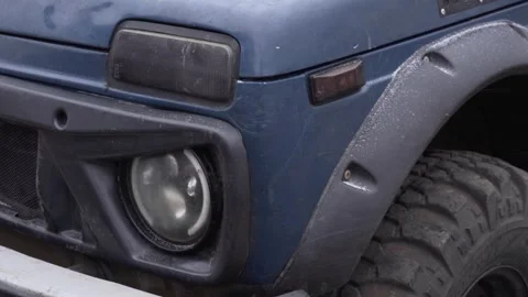 The front of the car before off-road racing. Headlight, wheel and hood of the Stock Footage 267088733
