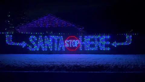 Front Christmas light on the wall Santa Stop Here Stock Footage 257077504