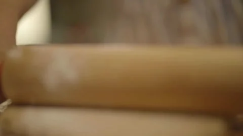 Front close-up of child rolling pin on dough Stockbeeldmateriaal 336374559