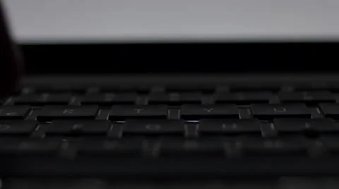 Front Close up male hand typing in dark room with laptop backlit keyboard. Stock Footage 68791920
