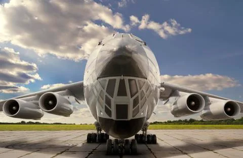 Front close up view of parked big jet airplane against a cloudy sky Stock Photos