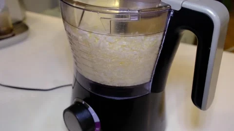 Front closeup shows cabbage pulsing inside a food chopper, measured bowl and Stock Footage 334044426