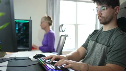 Front closeup view of young hip businessman in casual attire working on keyboard Stock Footage 151769243