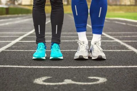 Front cropped view of two runners in running shoes. Stock-Fotos