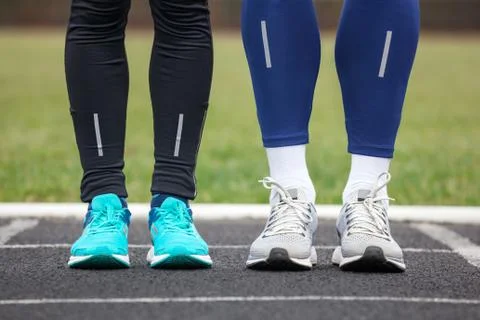Front cropped view of two runners in running shoes. Stock Photos