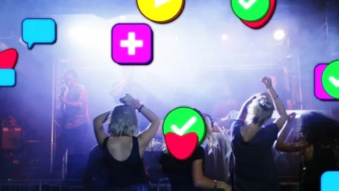 Front crowd dancing at music stage, social feed spawning hearts showing Stock Footage 334036511