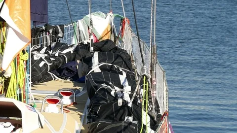 Front deck of racing clipper yacht in port with bags, ropes, Vídeo Stock 81451179