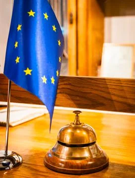 Front desk with europe union flag and protective shield dueto pandemic. Hospi Stock Photos