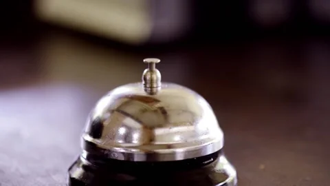 Front desk reception bell being rung struck slammed by hand 動画素材 166919350