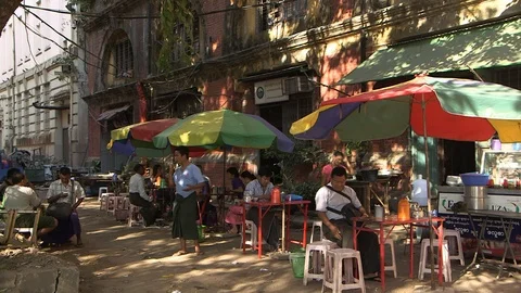 In front of a dilapidated colonial building. Yangon colonial heritage Stock Footage 114826616