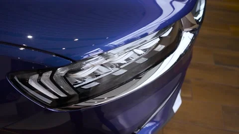 The front diode lamp of a new shiny car. Close-up of the front of a modern blue Video stock 156957271